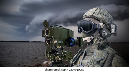 Navy Soldier. Laser Rangefinder Next To Soldier. Man In Camouflage Military Uniform. Equipment For Naval Army. Soldier Stands On Bank Of River. Military Technologies. Warrior In Face Mask And Helmet