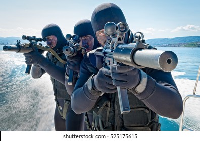 Navy Soldiers With Machine Guns In Hand On A Naval Ship.