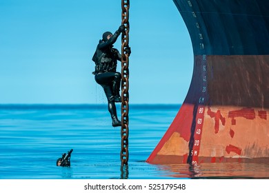 Navy Soldiers With Machine Guns In Hand, Climbing The Chain To The Boat.