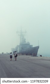 A Navy US Ship In The Naval Base Moored In The Fog