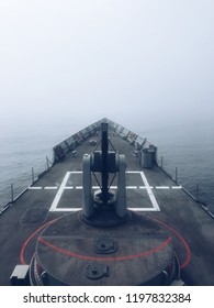 A Navy US Ship In The Naval Base Moored In The Fog