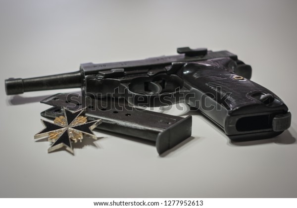 the nazi germany military\
automatic pistol with a magazine and iron cross. World war 2\
weapon