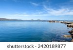 Nea Makri, Attica Greece. Panoramic view of vast Aegean calm sea background with rocky formation in the water. Destination for vacation.