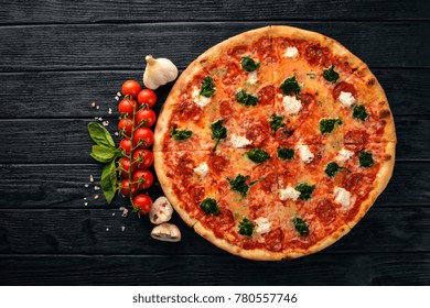 Neapolitan Pizza. Spinach, Gorgonzola Cheese, Sausage Salami. On A Wooden Background. Top View.