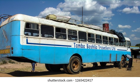 Near Chengi, Zambia, 11th June 2005: Men Changing Spare Tyre Of Travel Bus