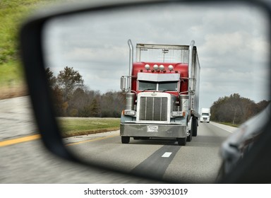 NEAR DALLAS, TX/USA - NOVEMBER 4, 2015: Peterbilt Truck Seen In The Rearview Mirror