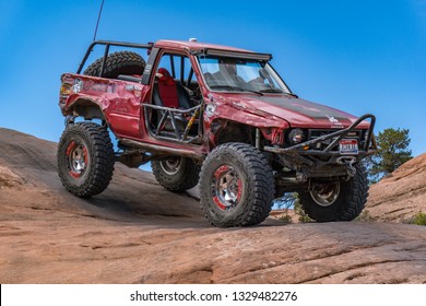 Near Moab, Utah, USA - 5/26/17 A Modified Toyota Pick-up Truck On Sandstone