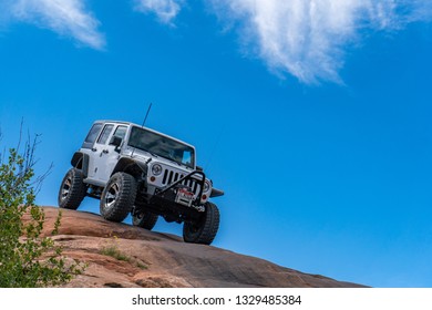 Near Moab, Utah, USA - 5/26/17 A Modified Jeep Wrangler On Sandstone