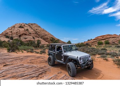 Near Moab, Utah, USA - 5/26/17 A Modified Jeep Wrangler On Sandstone