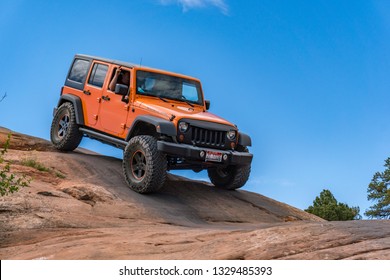 Near Moab, Utah, USA - 5/26/17 A Modified Jeep Wrangler On Sandstone