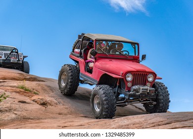 Near Moab, Utah, USA - 5/26/17 A Modified Jeep Wrangler On Sandstone