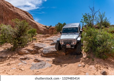 Near Moab, Utah, USA - 5/26/17 A Modified Jeep Wrangler On Sandstone