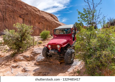 Near Moab, Utah, USA - 5/26/17 A Modified Jeep Wrangler On Sandstone