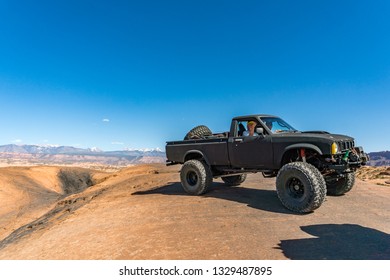 Near Moab, Utah, USA - 5/26/17 A Modified Toyota Pick-up Truck On Sandstone