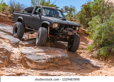 Near Moab, Utah, USA - 5/26/17 A Modified Toyota Pick-up Truck On Sandstone