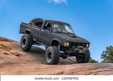 Near Moab, Utah, USA - 5/26/17 A Modified Toyota Pick-up Truck On Sandstone