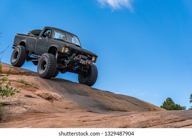 Near Moab, Utah, USA - 5/26/17 A Modified Toyota Pick-up Truck On Sandstone