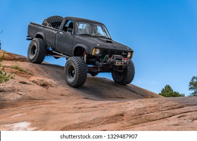 Near Moab, Utah, USA - 5/26/17 A Modified Toyota Pick-up Truck On Sandstone