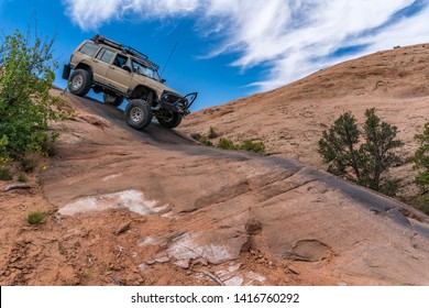 Near Moab, Utah, USA - 5/26/17 A Modified Jeep Cherokee On Sandstone