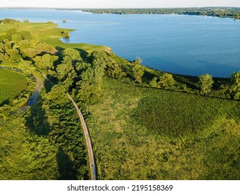 Near Oshkosh Wisconsin, A Trail Leads Out To The Brekawall On The Fox River During The Summer