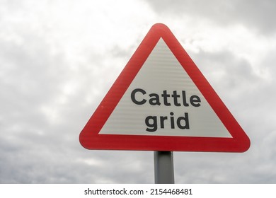 Near Walltown, Northumberland, UK - May 7th, 2022: A sign for a cattle grid - an indicator of the countryside, against a sunny clouded sky.