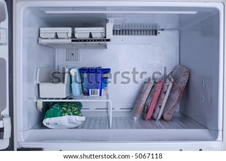 Nearly empty freezer with a cool blue tint