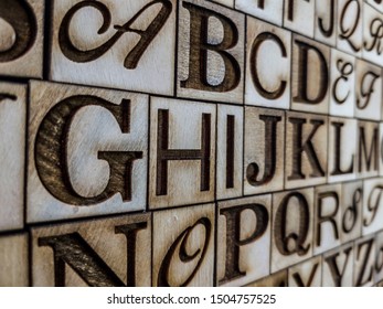 Neat And Engraved Alphabet On Aged Wood