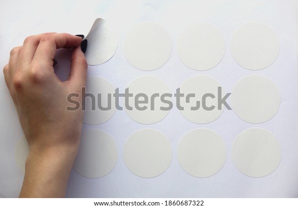 Download Neat Female Hand Peels Off Round Stock Photo Edit Now 1860687322