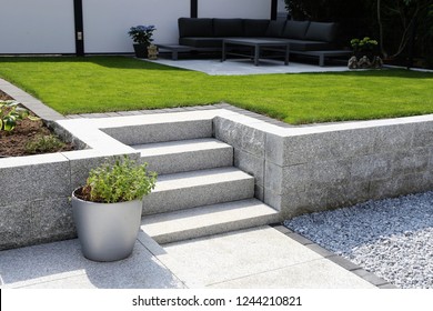 Neat And Tidy Garden With Granite Wall And Solid Block Steps