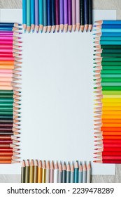 Neatly arraged composition tightly placed in gradient patterns crayons framing the sides rectangular mockup zone