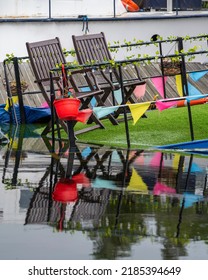 Neatly Arranged Deckchairs And Bunting On A Slowly Sinking Boat On The Canal