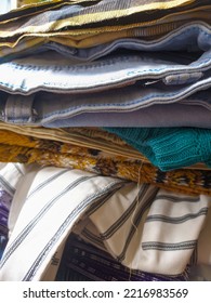 A Neatly Arranged Pile Of Various Neat Clothes And Pants After Ironing.