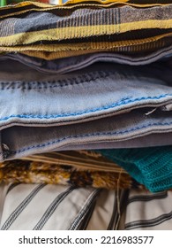 A Neatly Arranged Pile Of Various Neat Clothes And Pants After Ironing.