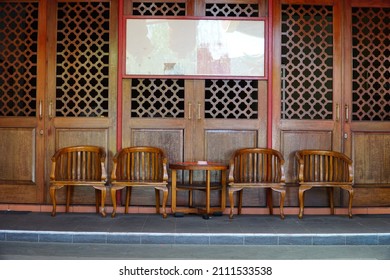 Neatly Arranged Wooden Chairs And Tables On The Terrace Of The House Against The Background Of The Wooden Door In The Chinese Temple