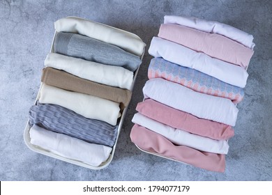 Neatly Folded Clothes In Open Organizer Boxes Top View On Stone Table. Marie Kondo Tidyng Method