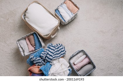 Neatly Folded Clothes In Open Organizer Boxes, Top View.