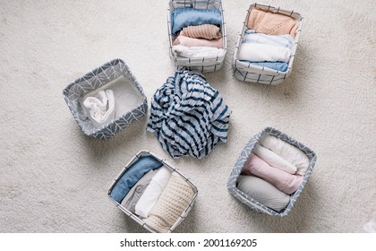 Neatly Folded Clothes In Open Organizer Boxes, Top View.