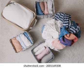 Neatly Folded Clothes In Open Organizer Boxes, Top View.