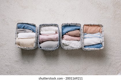 Neatly Folded Clothes In Open Organizer Boxes, Top View.