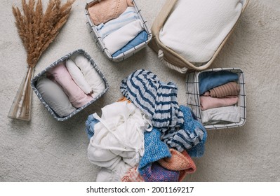 Neatly Folded Clothes In Open Organizer Boxes, Top View.