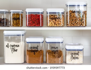 Neatly organized and labeled baking ingredients in BPA-free plastic storage containers - Shutterstock ID 1939397773