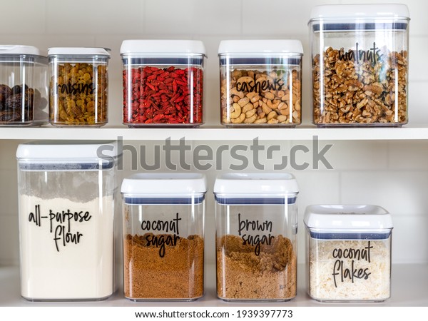 Neatly organized and labeled baking\
ingredients in BPA-free plastic storage\
containers