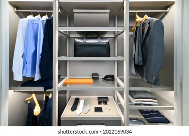 Neatly Organized Men's Closet With Suit, Shirt, Tie, And Other Business Attire.