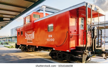 Nebraska, USA - Aug 8, 2017: Restored vintage red train carriage on public display at the Lincoln Haymarket area. Open to mainly pedestrian traffic, this area has a strong railroading heritage.