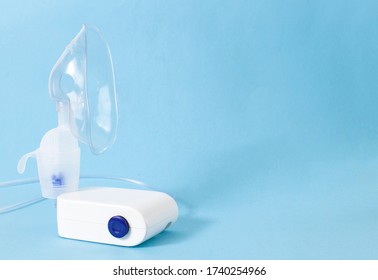 A Nebulizer Treatment Device For The Treatment Of Airway Inflammation, Cough And Pneumonia. Prevention Of Bronchial Asthma, Blue Background, Copy Space, Healthcare