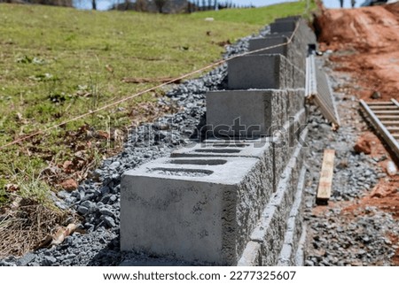 It was necessary to build retaining wall to near new home on property