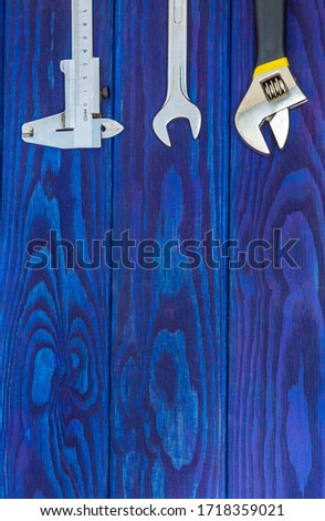 Necessary set of tools for plumbers on wooden blue boards with space for advertising