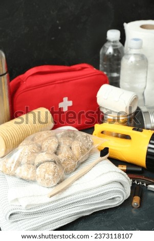 Necessities for emergency bag on dark table, closeup Сток-фото © 