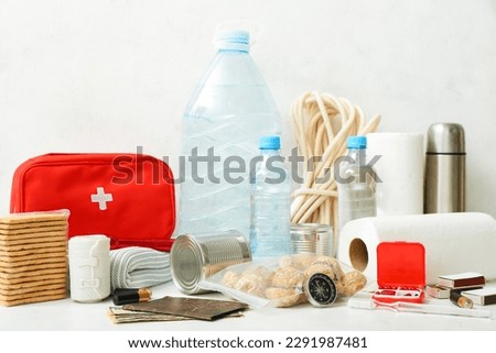Necessities for emergency bag on white table Сток-фото © 