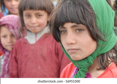 NECHEM, AFGHANISTAN - MAY 28: Young Girl Poses Seriously For The Camera On May 28, 2010 In Nechem, Afghanistan. She Has Just Started School And Is The First In Her Family To Receive An Education.